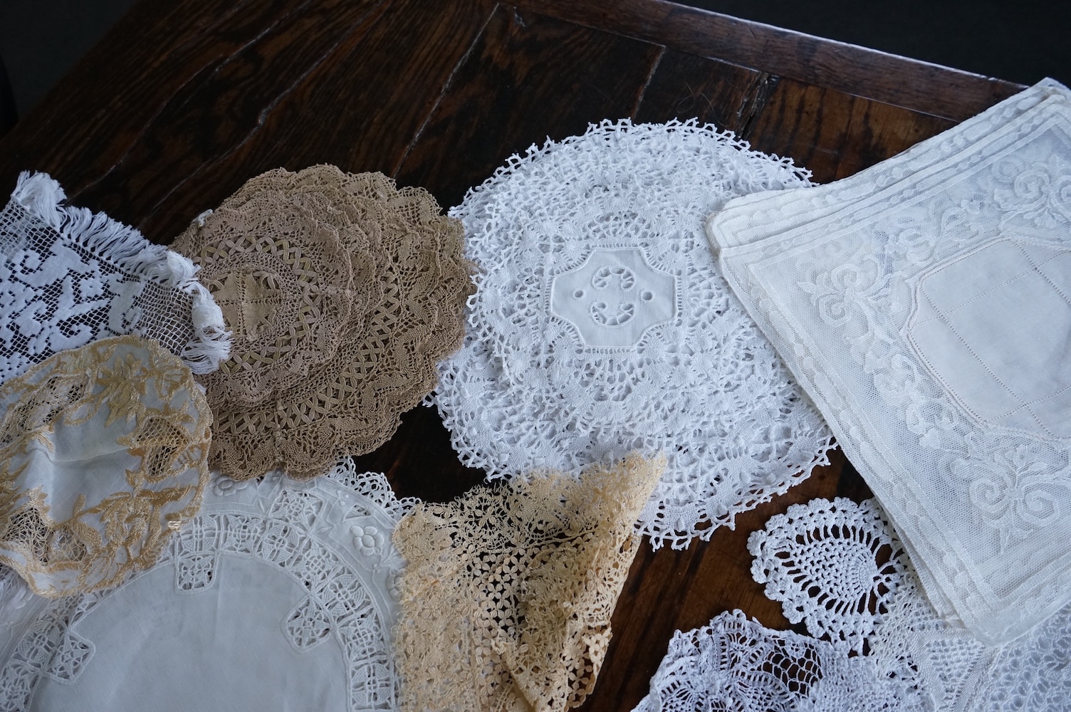 A 19th century large linen cut work collar, together with various sets of circular cut work mats, a tasselled pelmet and a collection of bobbin lace and tatting worked mats etc., Condition - mostly good